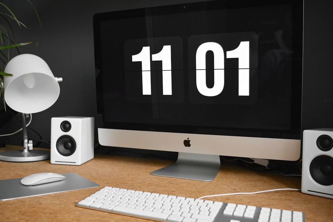 A modern workspace featuring dual computer monitors displaying web design projects, emphasizing technology and productivity.
